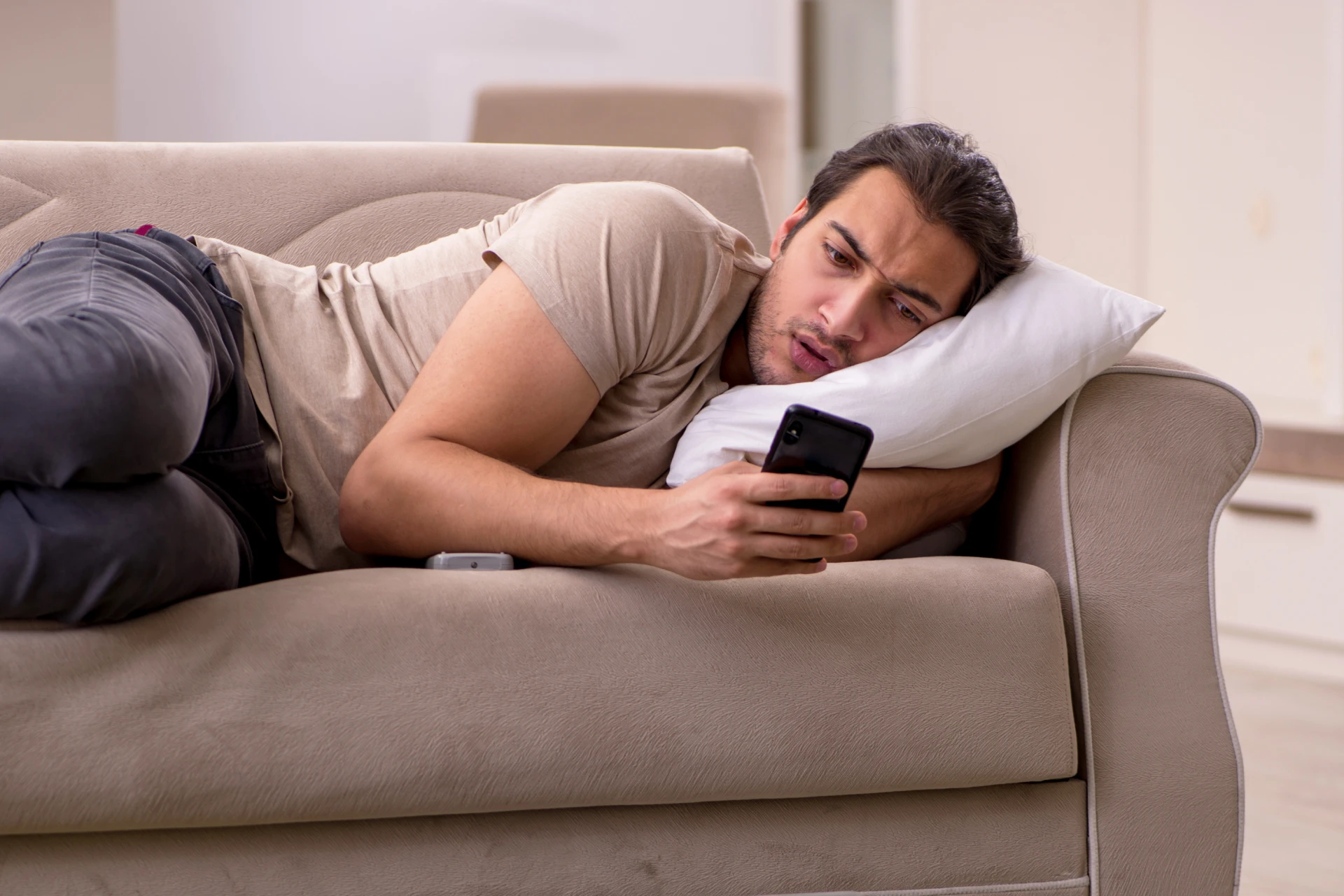 swiping_binge Man lying on couch on swiping binge