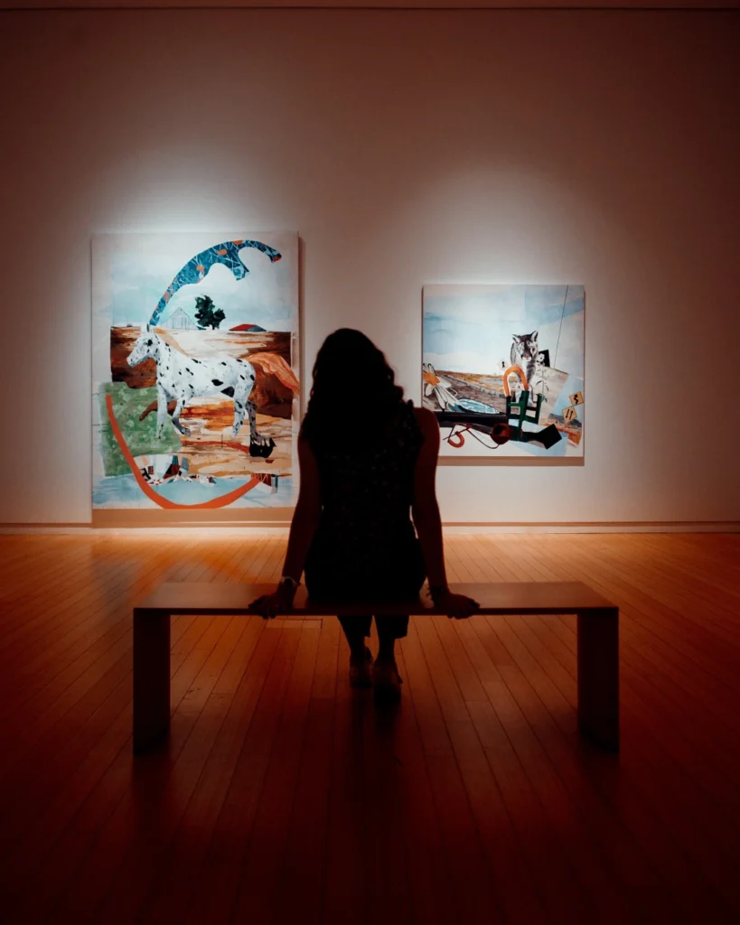 Woman sitting and contemplating a piece of art in a gallery