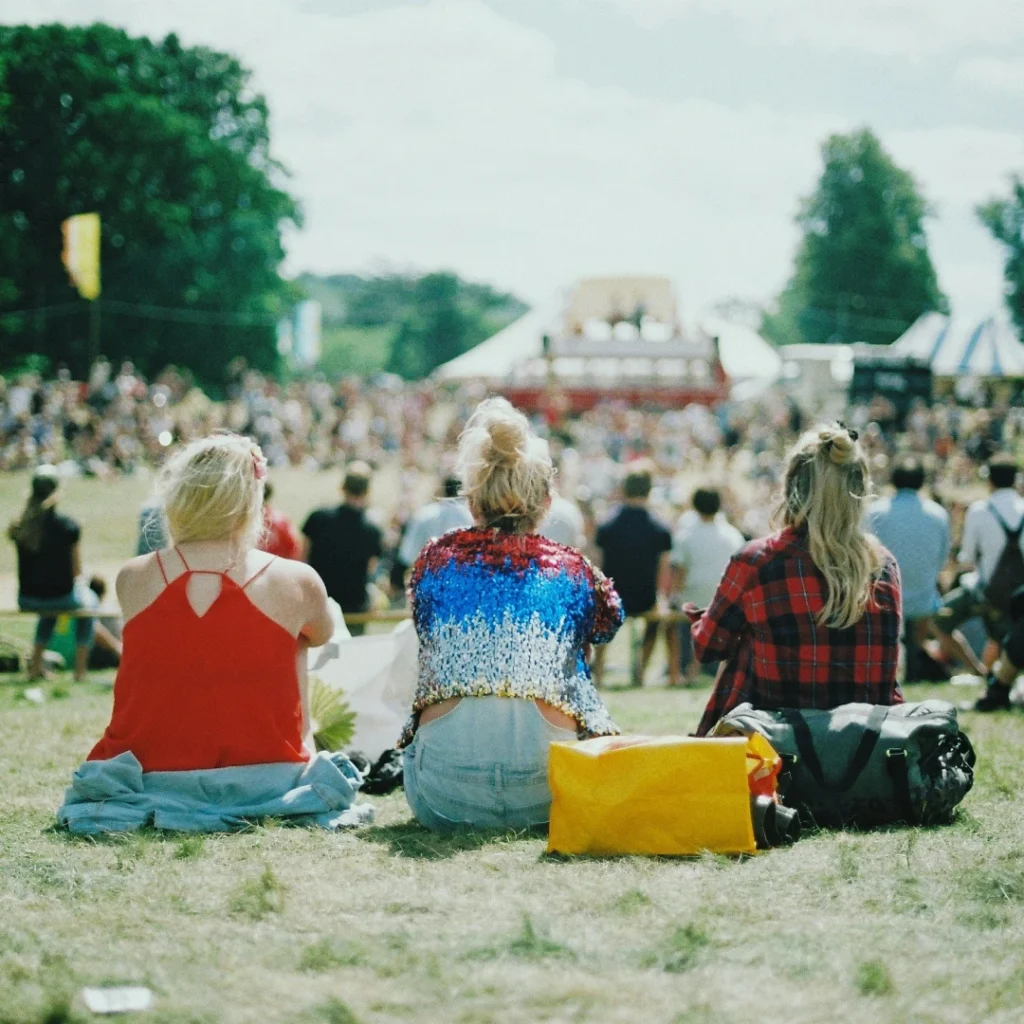 Woman sitting on the grass at a local community festival event