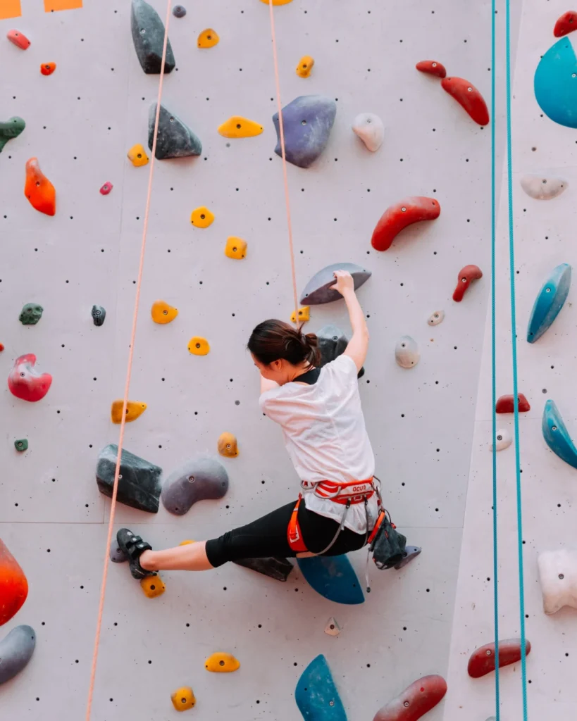 A woman doing indoor rock climbing