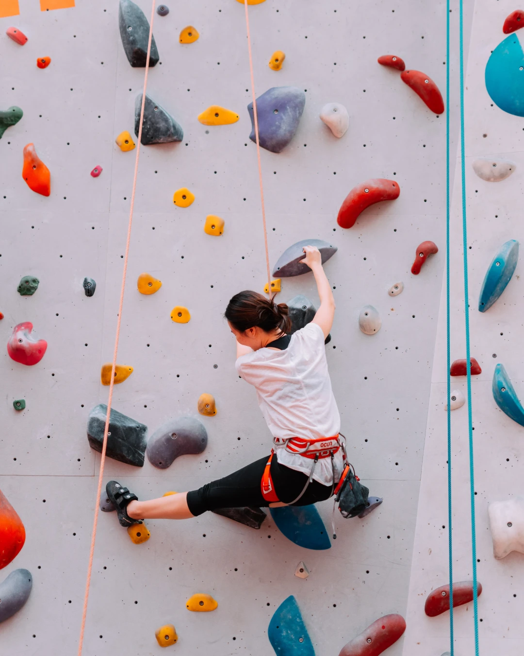 indoor-rock-climbing A woman doing indoor rock climbing