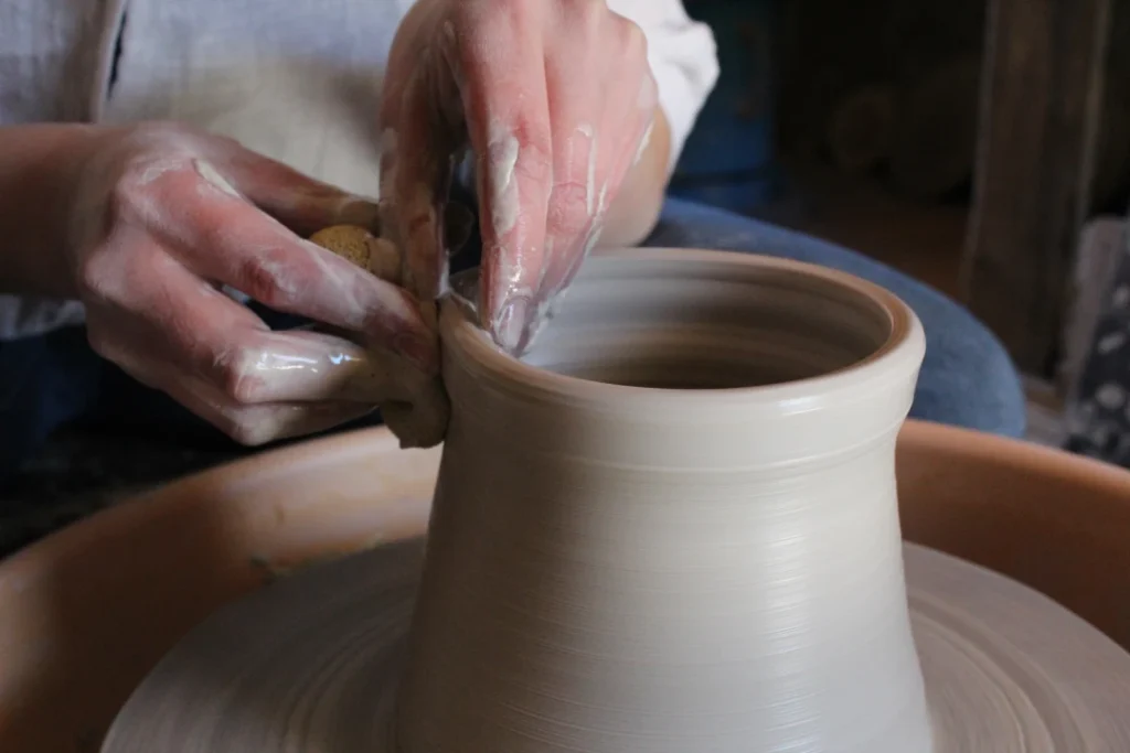 Close up of a person doing pottery
