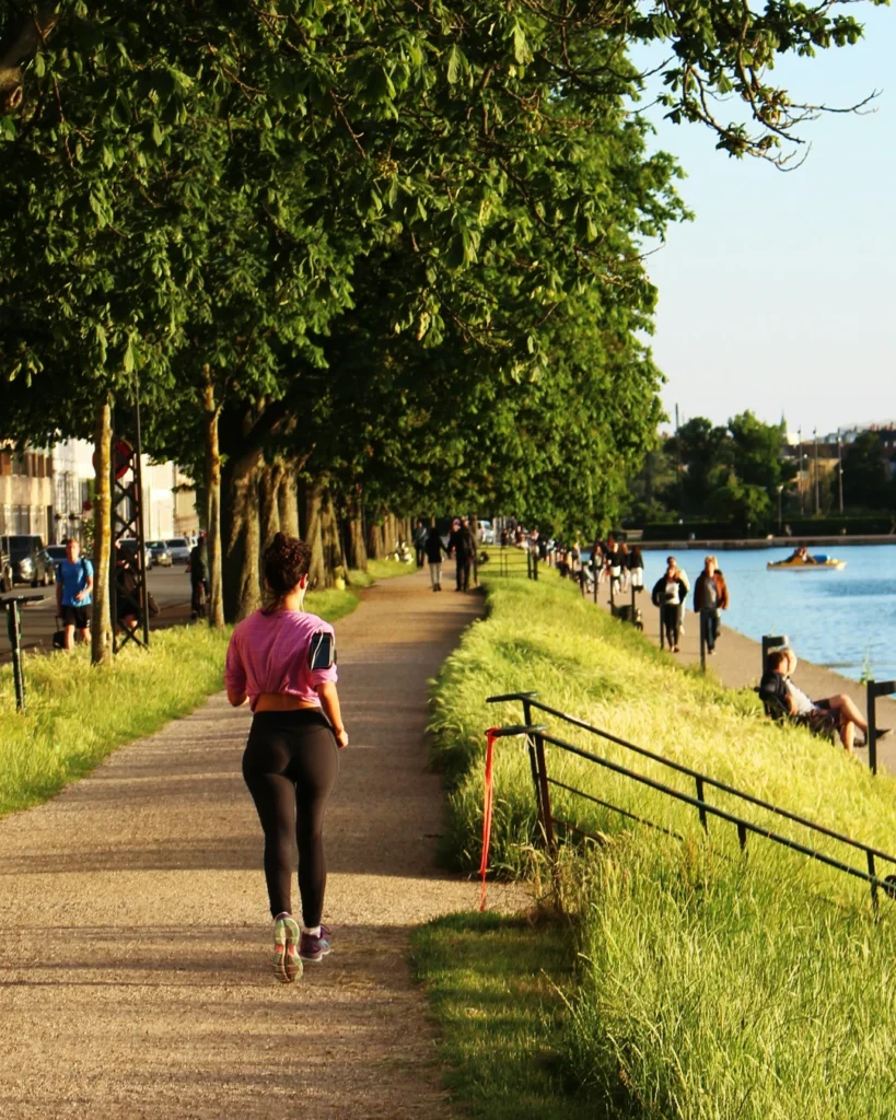 Woman running on a path alongside the water